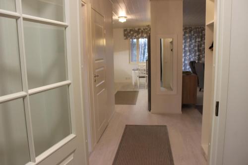 a hallway with sliding glass doors and a hallway with a dining room at Majoituspalvelu Nurmi Apartment Oksapolku 2 B Deluxe Huoneisto 103m2 in Raahe