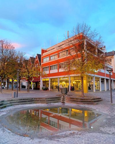 a building with a pond in the middle of a street at Hotel Well Garni in Wittlich