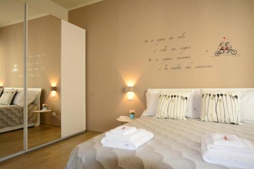 a bedroom with a bed with a writing on the wall at La Dotta Apartments in Bologna