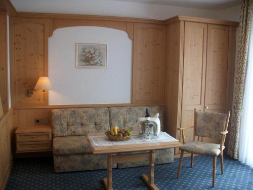 a living room with a couch and a table at Hotel Hessenhof in Winterberg
