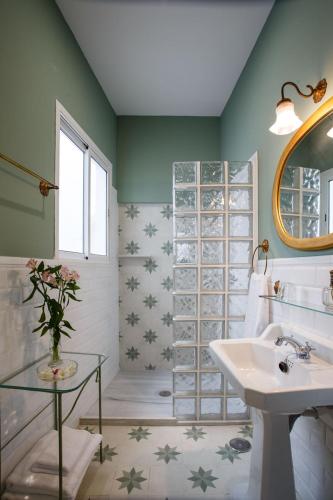 a bathroom with a sink and a mirror at Suites Machado in Seville