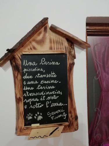 a sign in a wooden house with writing on it at La Casina in Stia