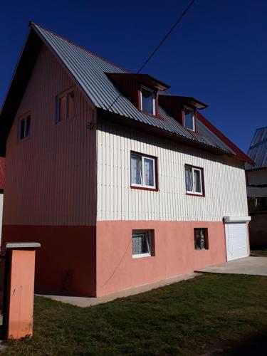 a red and white barn with a black roof at Vuk Popovic in Žabljak
