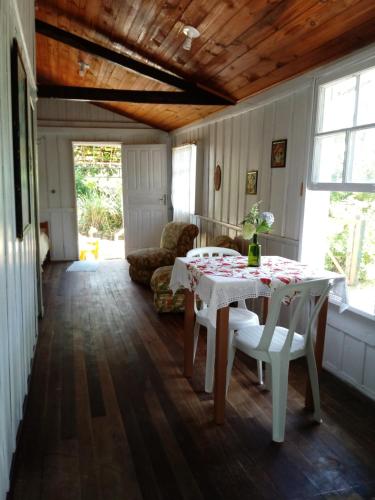 a dining room with a table and a couch at Casa na Praia do Matadeiro in Florianópolis