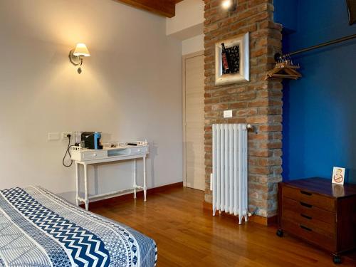 a bedroom with a bed and a brick wall at Porta Ronca - B&B, Suites & Apts in Rho
