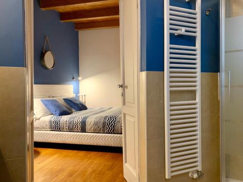 a bedroom with a bed and blue walls at Porta Ronca - B&B, Suites & Apts in Rho