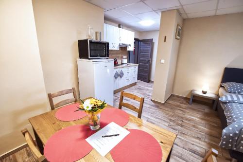 a kitchen and dining room with a table with flowers on it at Nice accommodation in Mikulov in Mikulov