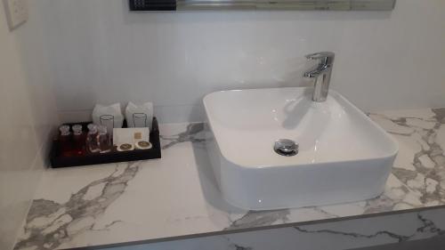 a white sink in a bathroom with a counter at Fill - Feel @ Long Beach Resort in Ko Lanta