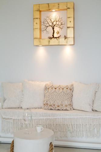 a living room with a white couch and a mirror at On The Rocks Antiparos in Antiparos Town
