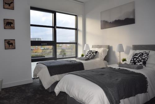 Un ou plusieurs lits dans un hébergement de l'établissement London City Island 3 Bedroom Luxury Apartments, Canary Wharf