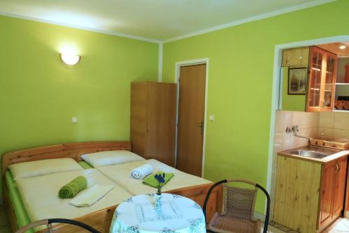 a bedroom with a bed with a table and a sink at Apartmán pri zámočku in Bešeňová
