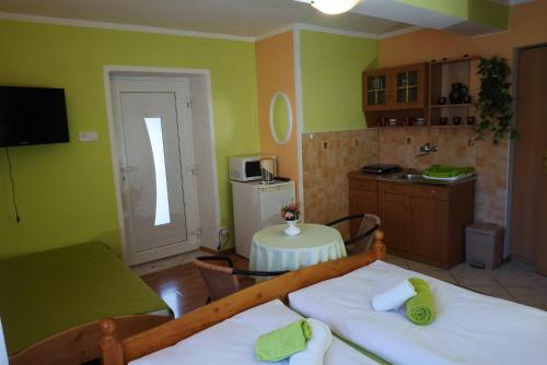 a kitchen with two beds and a table in a room at Apartmán pri zámočku in Bešeňová