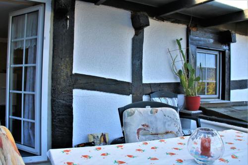 a table with a chair sitting at a table with a table cloth at Stellina in Eitorf