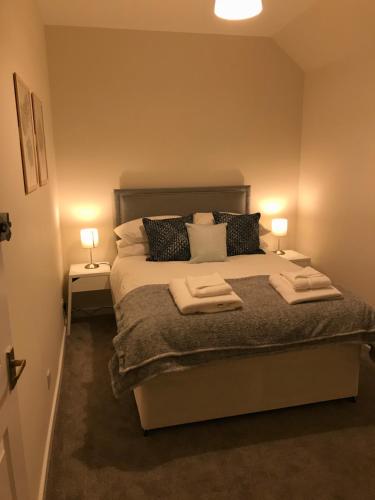 a bedroom with a bed with two towels on it at 2 Lower Kessock Street in Inverness