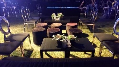 a group of tables and chairs with flowers on them at La Mansión Residency Suites Ensenada in Ensenada