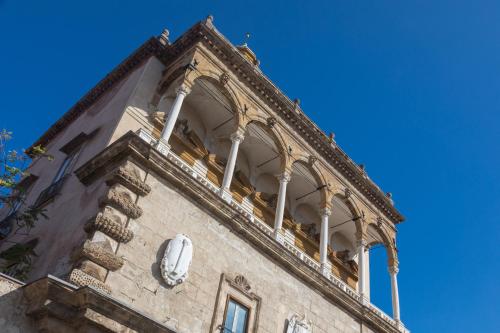 a stone building with a balcony on top of it at I Mori di Porta Nuova Suite & Terrace in Palermo