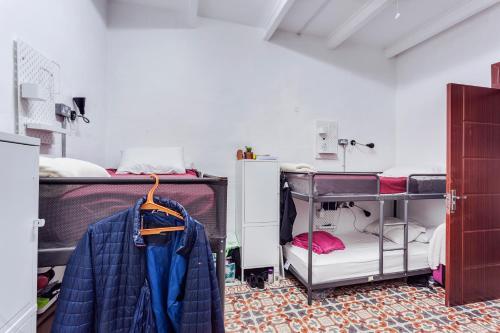 a room with two bunk beds and a closet at Granny's Inn Hostel in Sliema