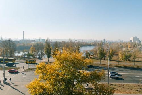 a parking lot with cars parked next to a lake at Apartment Obolon Natalka Park in Kyiv