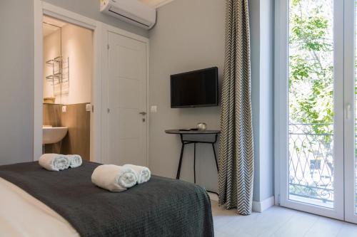 a bedroom with a bed with towels on it at I Mori di Porta Nuova Suite & Terrace in Palermo