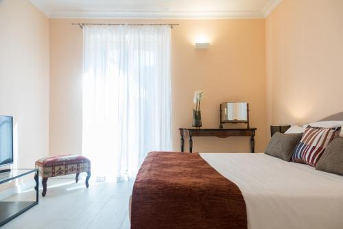 a bedroom with a bed and a large window at I Mori di Porta Nuova Suite & Terrace in Palermo