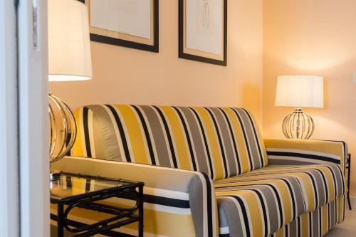 a living room with a couch and a table at I Mori di Porta Nuova Suite & Terrace in Palermo