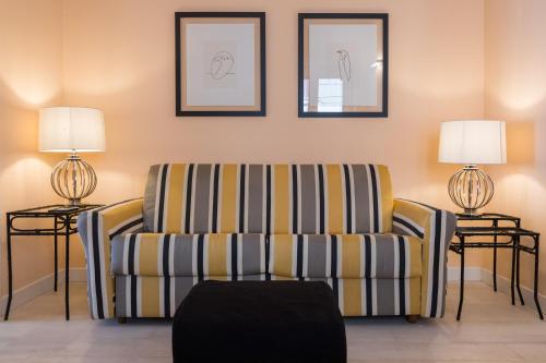 a living room with a couch and two lamps at I Mori di Porta Nuova Suite & Terrace in Palermo