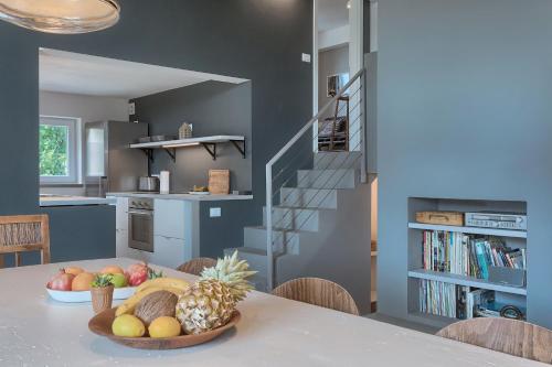 a kitchen with a table with a bowl of fruit on it at Casa Mia Apartments in Premantura