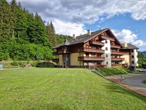 a large building with a large lawn in front of it at Apartmán ENZO č 103 Tále Chopok Juh in Tale