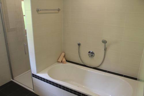 a bath tub in a bathroom with a shower at Volggerhof in Racines