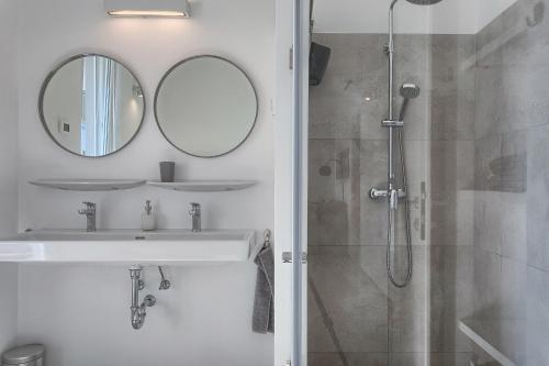 a bathroom with a sink and a mirror at Casa Mia Apartments in Premantura