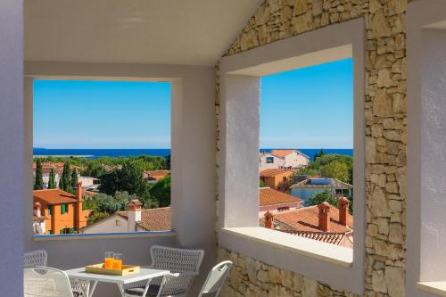 a room with a window with a view of the city at Casa Mia Apartments in Premantura