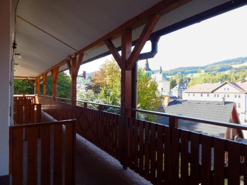 a balcony of a house with a view of a town at Apartmán 466 in Rokytnice nad Jizerou