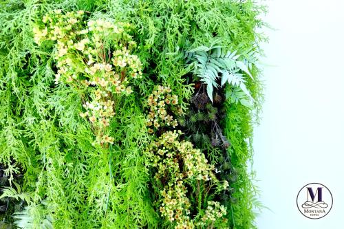 a green wall with plants and flowers on it at Montana Hotel Songkhla in Songkhla