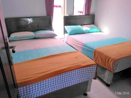 Ένα ή περισσότερα κρεβάτια σε δωμάτιο στο Villa Batu Safir