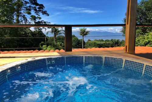 a swimming pool with a view of the ocean at Casa Vistas del Conde in Heredia
