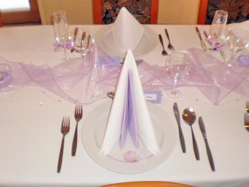 a white table with silverware and napkins on it at Hotel Vltava in Strážné