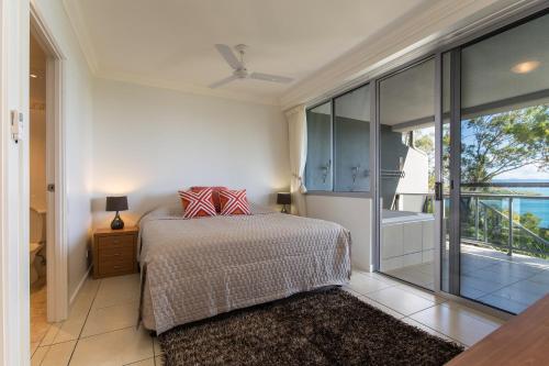 a bedroom with a bed and a large window at Blue Water Views on Hamilton Island by HIHA in Hamilton Island