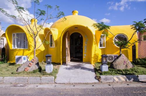 a yellow house with a front entrance to it at Kenting Ha-Bi Star Fort in Hengchun