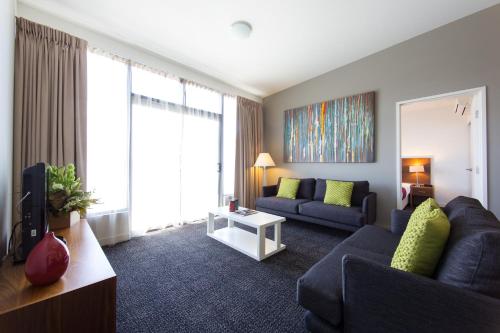 a living room filled with furniture and a window at Quest Albury in Albury