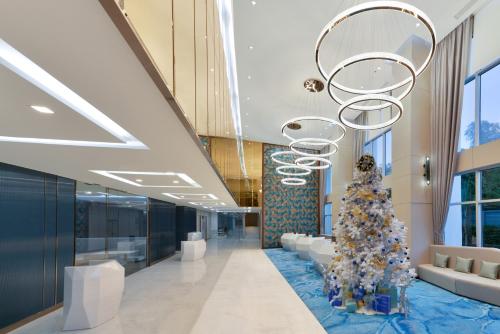 a christmas tree in the lobby of a building at Centre Point Prime Hotel Pattaya in Pattaya North