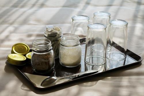 a tray with jars and spoons on a bed at Villa Rumah Bromo in Bromo