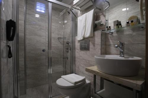 a bathroom with a shower and a sink and a toilet at NL Amsterdam Hotel in Istanbul