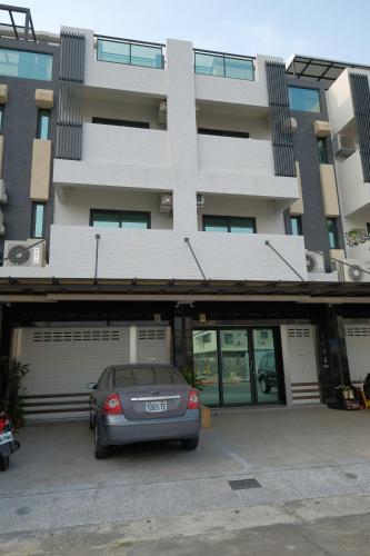 a car parked in a parking lot in front of a building at Sumu X Sumu in Donggang