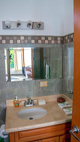 a bathroom with a sink and a mirror at CW2 Casa Wasabi 2bed+1bath in Tamarindo