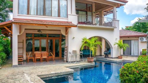 a house with a swimming pool in front of a house at CW2 Casa Wasabi 2bed+1bath in Tamarindo