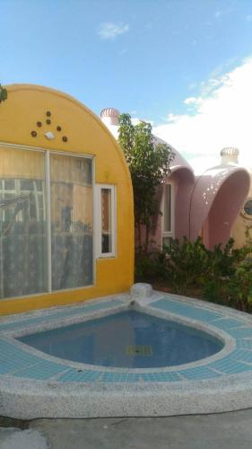 a house with a swimming pool in front of it at Kenting Ha-Bi Star Fort in Hengchun