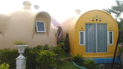 a yellow and white house with a window at Kenting Ha-Bi Star Fort in Hengchun