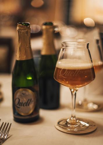 two bottles of beer and a glass of beer at Palais Bad Ragaz in Bad Ragaz