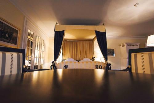 a large table in a room with a bed at Palais Bad Ragaz in Bad Ragaz