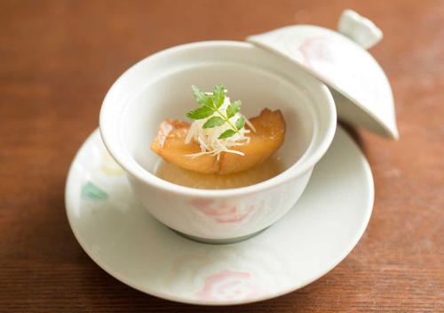 a bowl of food on a plate on a table at Aura Tachibana in Hakone